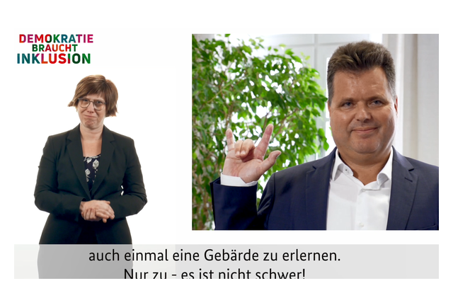 Jürgen Dusel - Behindertenbeauftragter der Bundesregierung und Gebärdensprachdolmetscherin